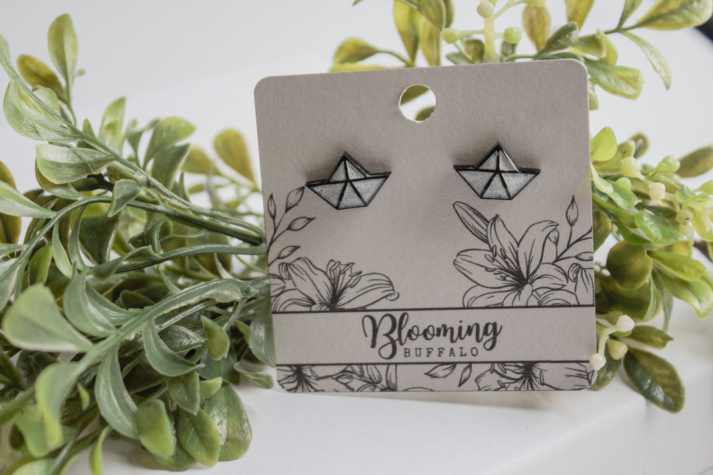 black and white origami paper boat stud earrings on Blooming Buffalo branded earring card