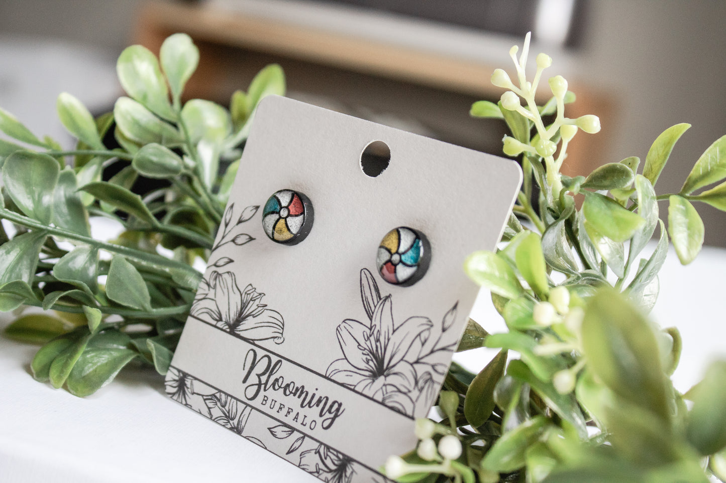 Red, White, Yellow and blue beach ball stud earring on Blooming Buffalo branded earring card
