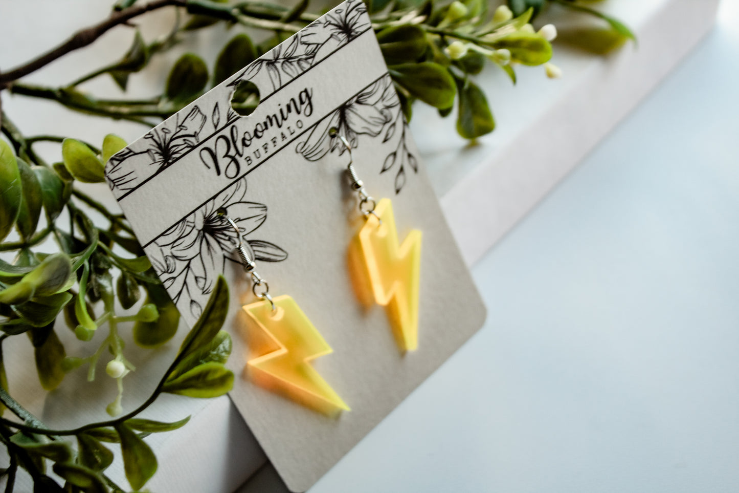 fluorescent yellow lightning bolt dangle earrings on Blooming Buffalo branded earring card