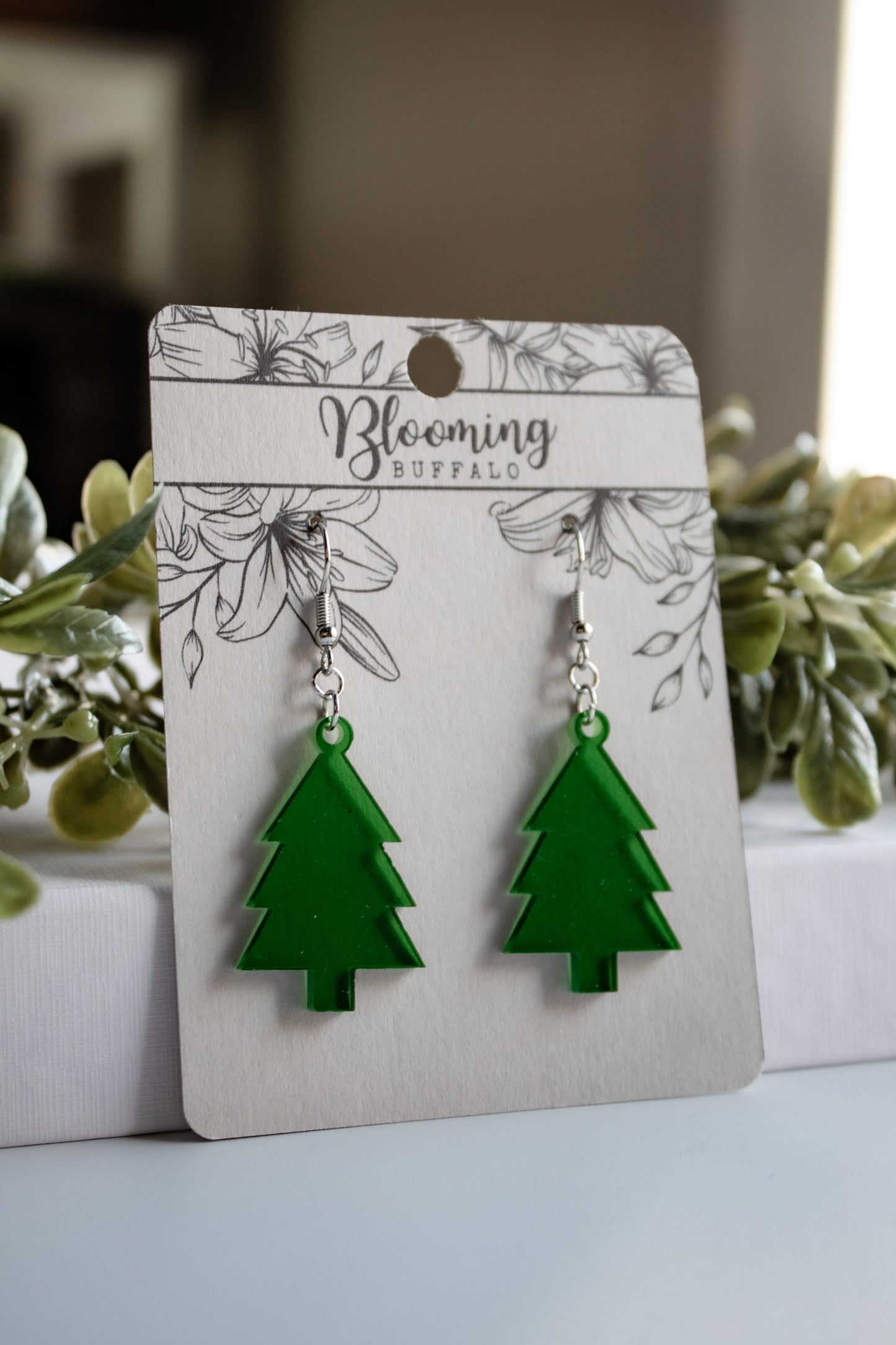 translucent green evergreen winter tree dangle earrings on Blooming Buffalo branded earring card