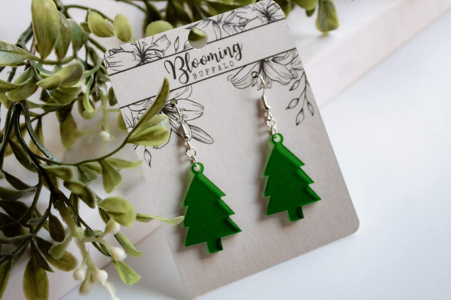 translucent green evergreen winter tree dangle earrings on Blooming Buffalo branded earring card