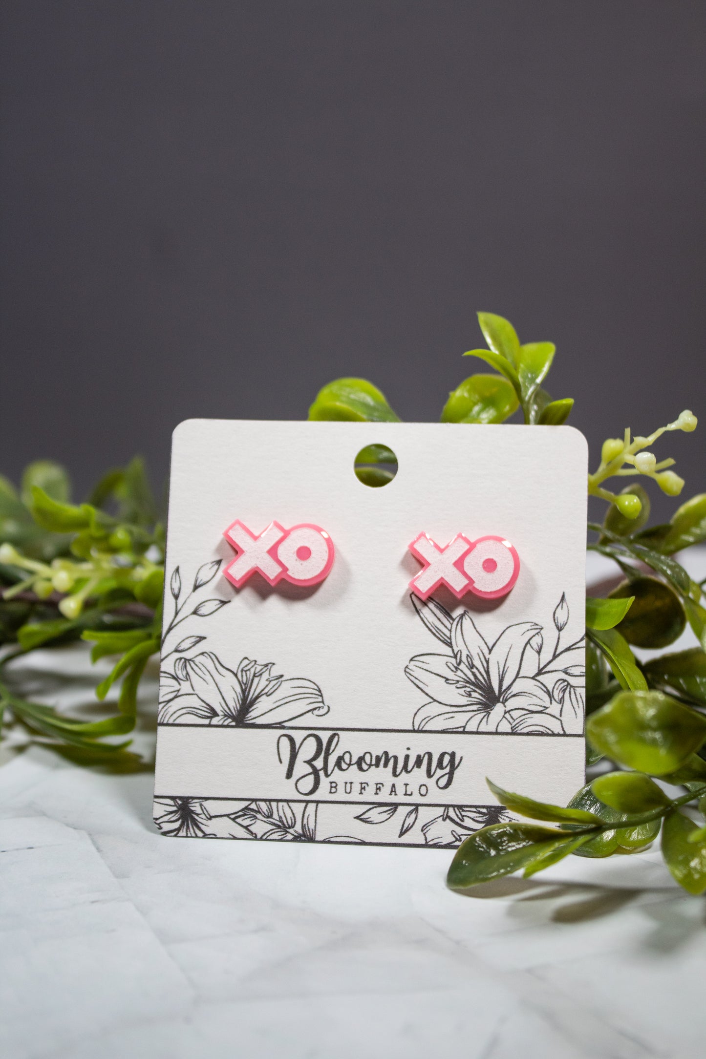 pink and white XO stud earrings on Blooming Buffalo branded earring card