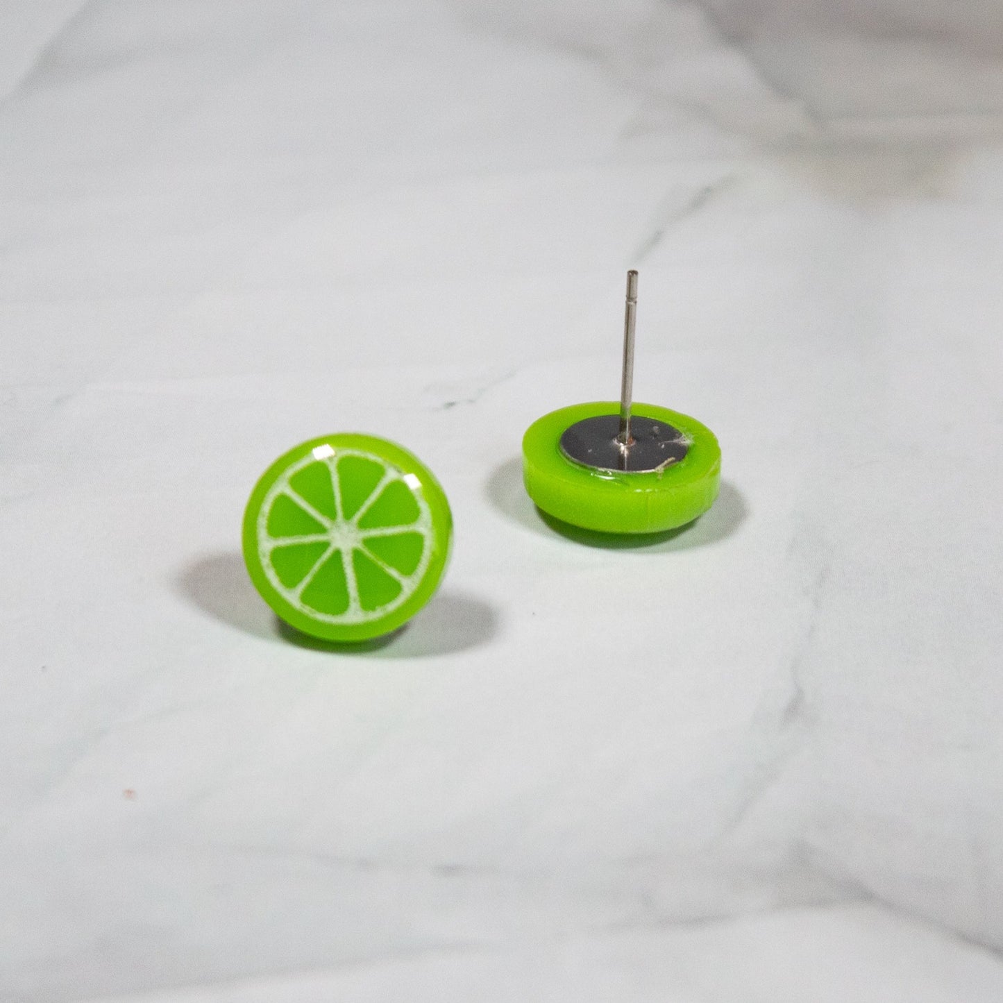 vibrant green lime style stud earring on white marbled background