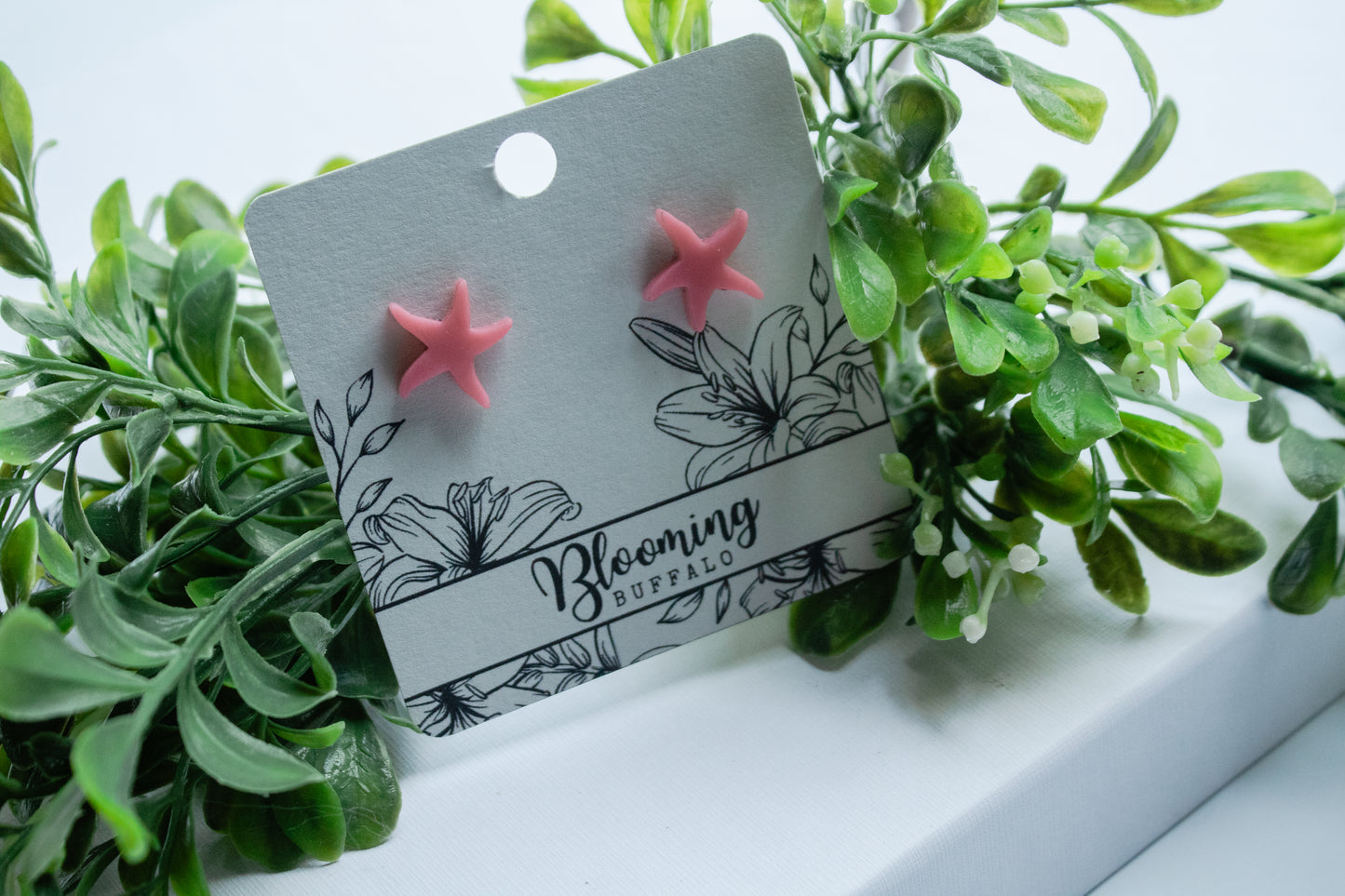 vibrant summery pink starfish style stud earrings on Blooming Buffalo branded earring card