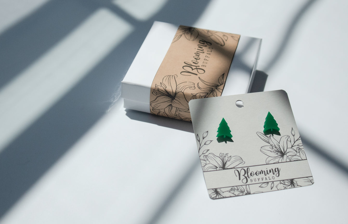 vibrant green evergreen tree shaped stud earrings on Blooming Buffalo branded earring card