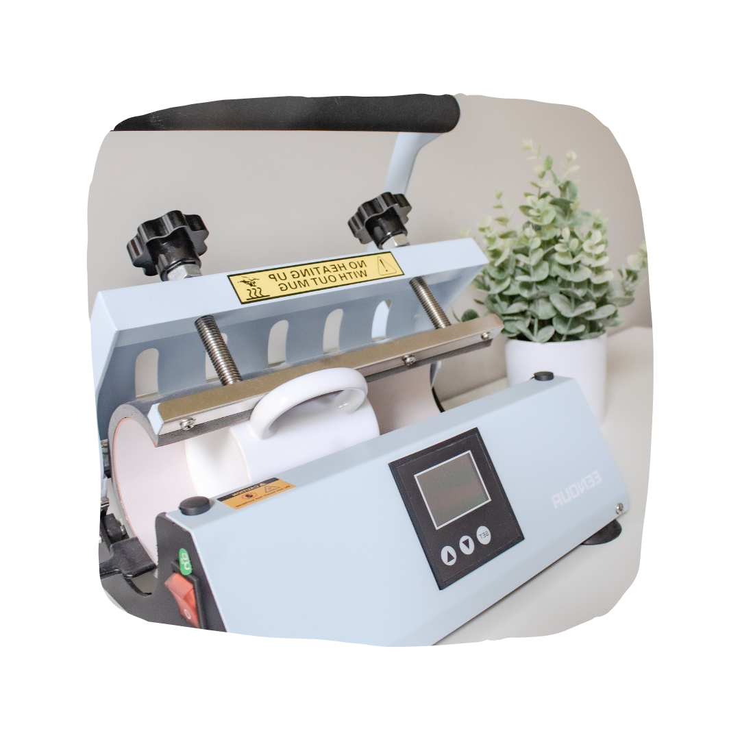 A bright workstation featuring a heat press with a blank mug heating up.